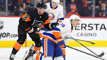 Apr 12, 2025; Philadelphia, Pennsylvania, USA; Philadelphia Flyers defenseman Cam York (8) attempts to free his stick against New York Islanders left wing Pierre Engvall (18) in the first period at Wells Fargo Center. Mandatory Credit: Kyle Ross-Imagn Images