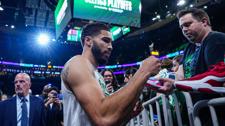 May 9, 2024; Boston, Massachusetts, USA; Boston Celtics forward Jayson Tatum (0) signs autographs.