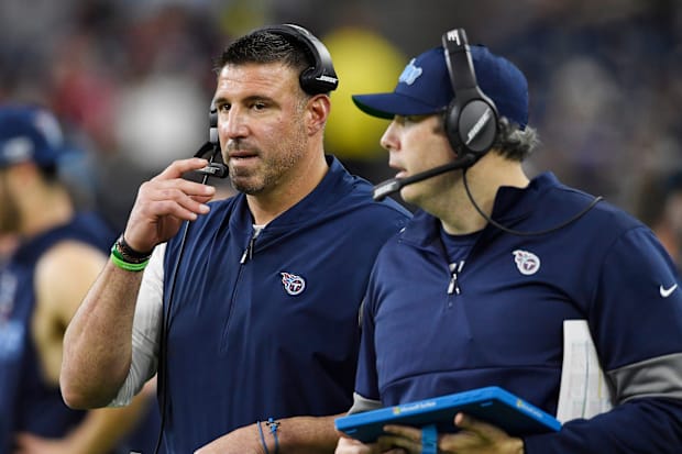 Football coaches speak during game