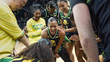 Oregon’s Deja Kelly, center, celebrates with teammate after the Ducks upset Baylor game at Matthew Knight Arena in Eugene.
