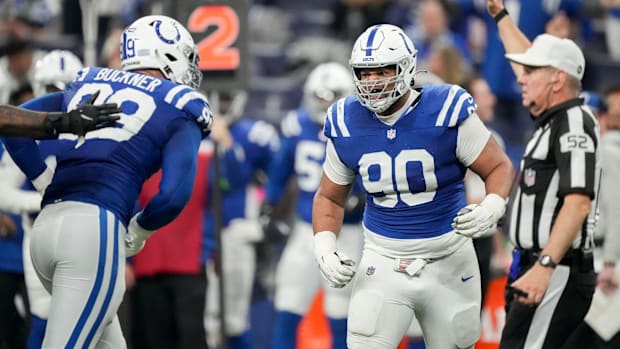 Colts defensive tackle Grover Stewart (blue jersey; white helmet) celebrates with a teammate after a big defensive stop. 