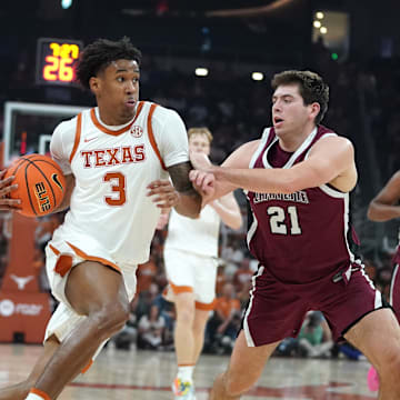 Texas Longhorns guard Dailyn Swain dribbles against Lafayette Leopards guard Andrew Phillips during the second quarter at Moody Center.