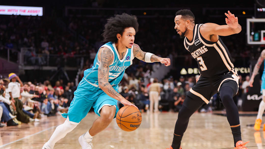 Feb 7, 2026; Atlanta, Georgia, USA; Charlotte Hornets guard Tre Mann (23) drives on Atlanta Hawks guard CJ McCollum (3) in the fourth quarter at State Farm Arena. Mandatory Credit: Brett Davis-Imagn Images