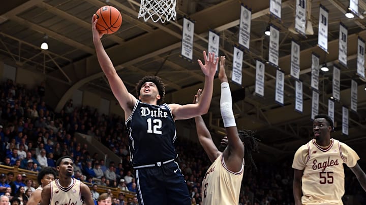 Feb 3, 2026; Durham, North Carolina, USA;  Duke Blue Devils forward Cameron Boozer (12) shoots in front of Boston College Eagles forward Jayden Hastings (22).