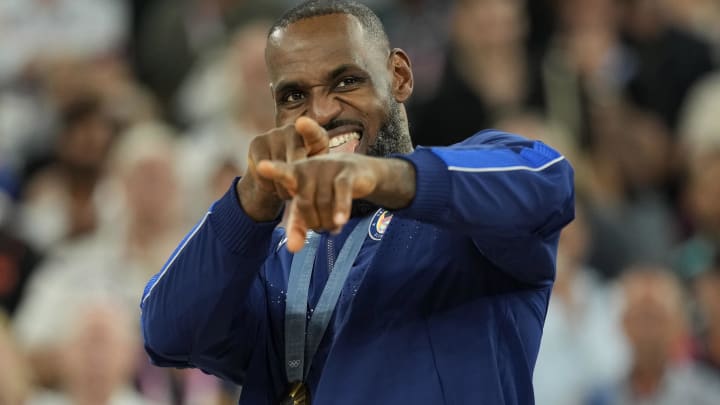 Aug 10, 2024; Paris, France; United States guard LeBron James (6) celebrates with the gold medal after the game against France in the men's basketball gold medal game during the Paris 2024 Olympic Summer Games at Accor Arena.