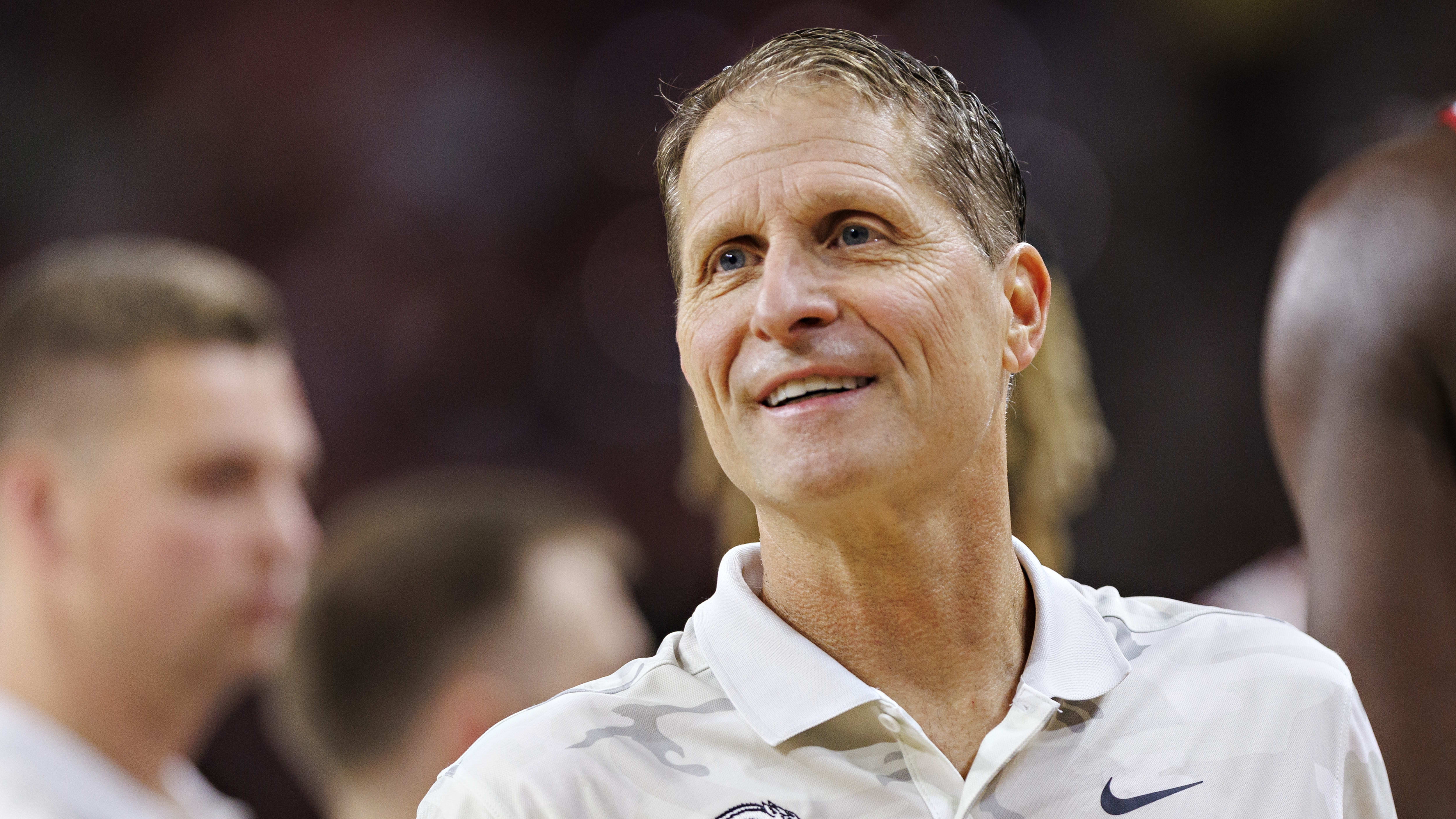 Eric Musselman smiles during a timeout.