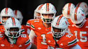 Nov 15, 2025; Miami Gardens, Florida, USA; Miami Hurricanes quarterback Carson Beck (center) enters the field to warm up before the game against NC State Wolfpack at Hard Rock Stadium. Mandatory Credit: Sam Navarro-Imagn Images