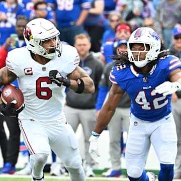 Sep 8, 2024; Orchard Park, New York, USA; Arizona Cardinals running back James Conner (6) runs against Buffalo Bills linebacker Dorian Williams (42) in the first quarter at Highmark Stadium. Mandatory Credit: Mark Konezny-Imagn Images