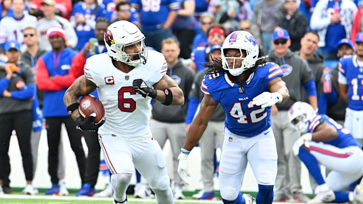 Sep 8, 2024; Orchard Park, New York, USA; Arizona Cardinals running back James Conner (6) runs against Buffalo Bills linebacker Dorian Williams (42) in the first quarter at Highmark Stadium. Mandatory Credit: Mark Konezny-Imagn Images