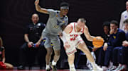 Mar 4, 2025; Salt Lake City, Utah, USA; Utah Utes guard Mason Madsen (45) dribbles against West Virginia Mountaineers guard Sencire Harris (10) during the first half at Jon M. Huntsman Center. Mandatory Credit: Rob Gray-Imagn Images