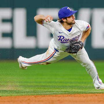 Sep 4, 2024; Arlington, Texas, USA; Texas Rangers shortstop Josh Smith (8) attempts to make a throw over to first base during the third inning against the New York Yankees at Globe Life Field. Mandatory Credit: Andrew Dieb-Imagn Images