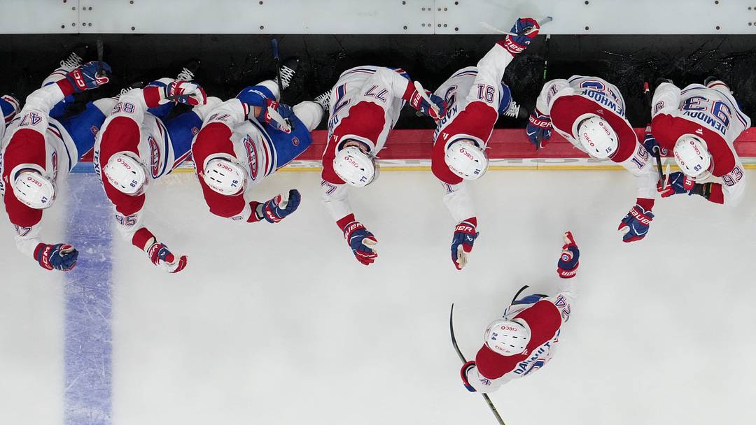 May 21, 2026; Raleigh, North Carolina, USA; Montreal Canadiens center Phillip Danault (24) celebrates with teammates after scoring a goal against the Carolina Hurricanes during the first period in game one of the Eastern Conferene Final of the 2026 Stanley Cup Playoffs at Lenovo Center. Mandatory Credit: James Guillory-Imagn Images