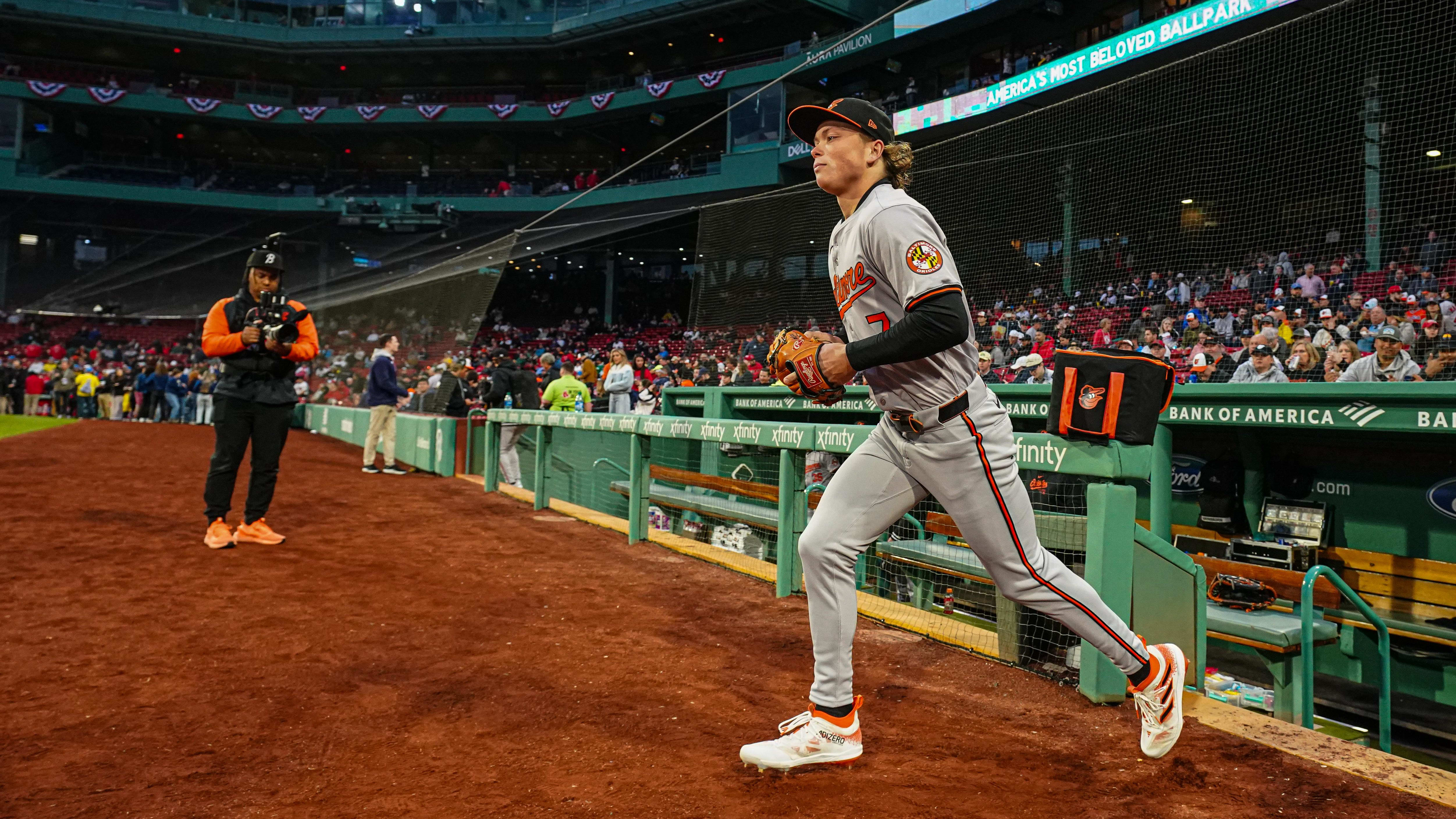 Baltimore Orioles shortstop Jackson Holliday runs onto the field at Fenway Park.