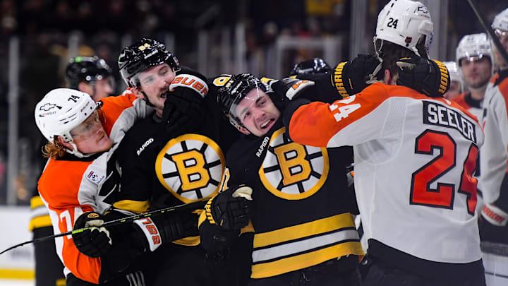 Jan 29, 2026; Boston, Massachusetts, USA; Philadelphia Flyers right wing Owen Tippett (74), Boston Bruins left wing Tanner Jeannot (84), center Michael Eyssimont (81), and defenseman Nick Seeler (24) grapple during the third period at TD Garden.