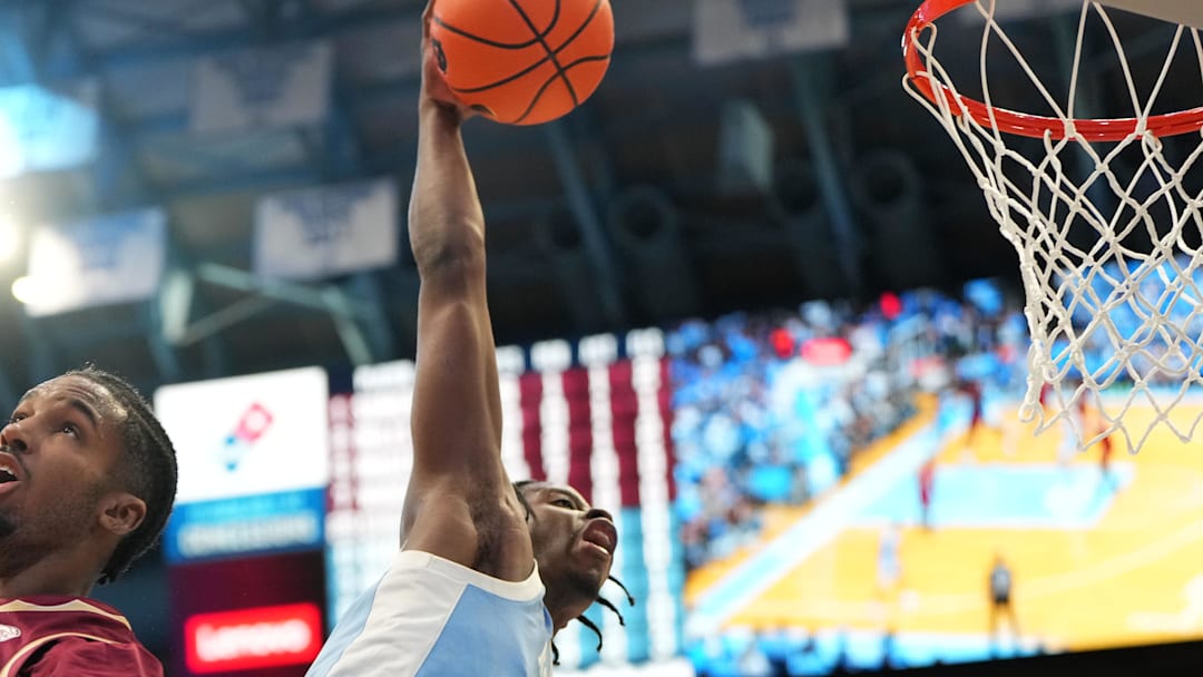 Dec 30, 2025; Chapel Hill, North Carolina, USA; North Carolina Tar Heels forward Caleb Wilson (8) scores as Florida State Seminoles forward Chauncey Wiggins (7) defends in the second half at Dean E. Smith Center. Mandatory Credit: Bob Donnan-Imagn Images