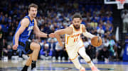 Apr 15, 2025; Orlando, Florida, USA; Atlanta Hawks guard Trae Young (11) controls the ball against the Orlando Magic in the first quarter at Kia Center. Mandatory Credit: Nathan Ray Seebeck-Imagn Images