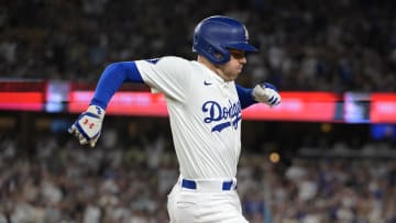 Jul 22, 2024; Los Angeles, California, USA;  Los Angeles Dodgers first baseman Freddie Freeman (5) beats the throw to San Francisco Giants first baseman LaMonte Wade Jr. (31) for a single in the eighth inning at Dodger Stadium. Mandatory Credit: Jayne Kamin-Oncea-USA TODAY Sports