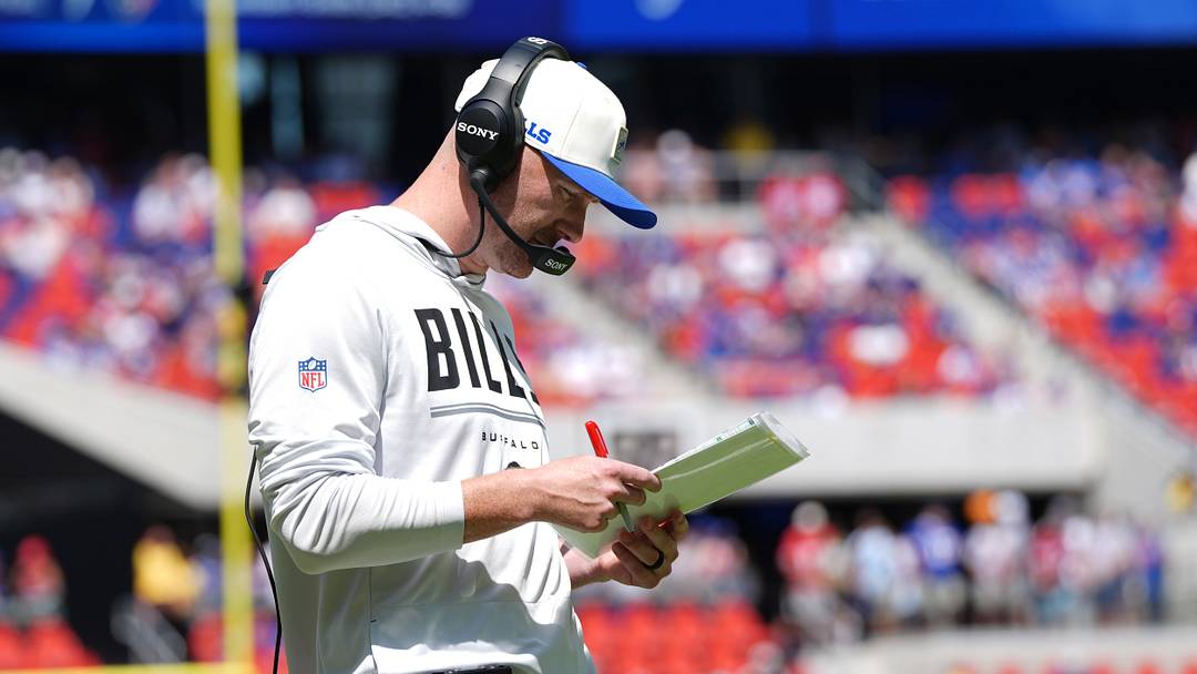 Aug 15, 2026; Orchard Park, New York, USA; Buffalo Bills head coach Joe Brady looks at his play card during the first half aginst the Carolina Panthers at New Highmark Stadium.