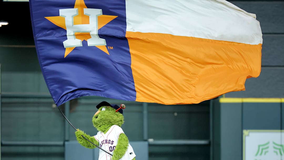 May 22, 2025; Houston, Texas, USA; Houston Astros mascot Orbit waves a flag in center field after the final out  against the Seattle Mariners during the ninth inning at Daikin Park. Mandatory Credit: Erik Williams-Imagn Images