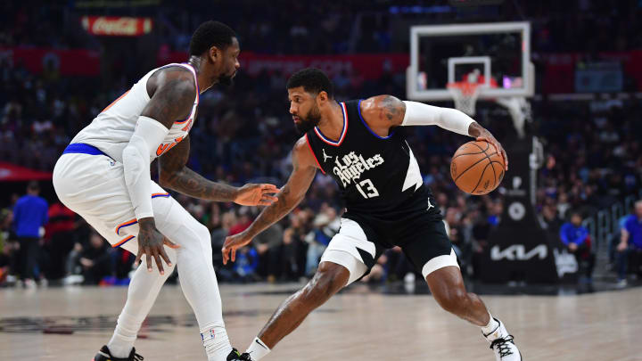 Dec 16, 2023; Los Angeles, California, USA; Los Angeles Clippers forward Paul George (13) moves the ball against New York Knicks forward Julius Randle (30) during the first half at Crypto.com Arena. Mandatory Credit: Gary A. Vasquez-USA TODAY Sports