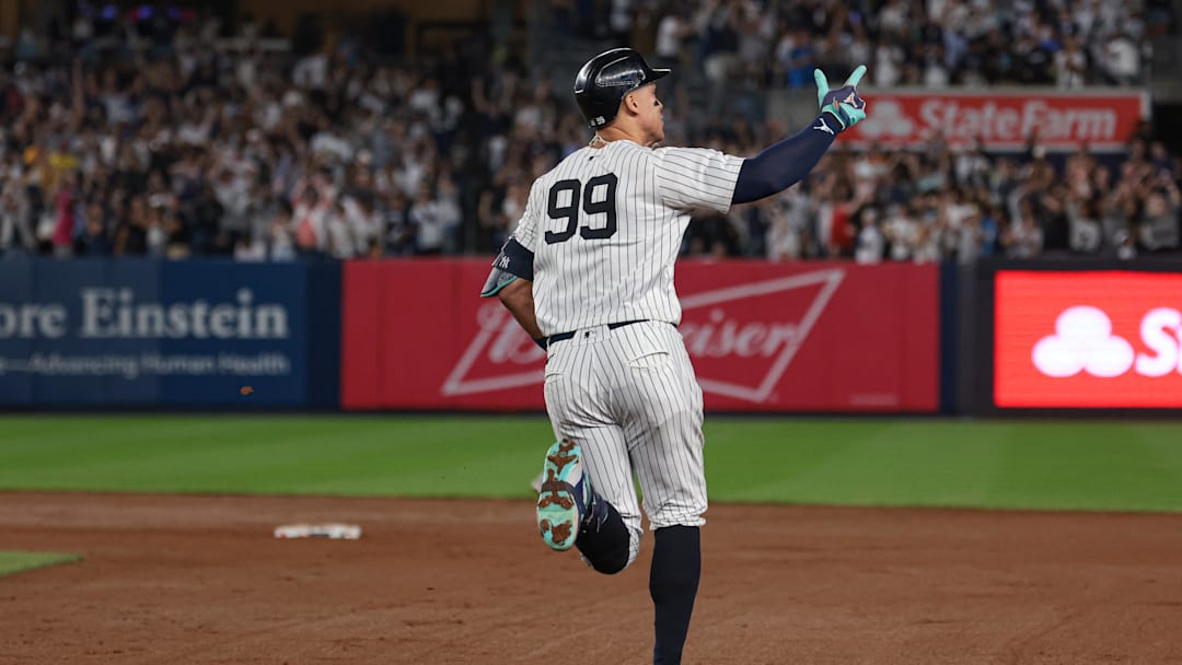 Sep 13, 2024; Bronx, New York, USA; New York Yankees center fielder Aaron Judge (99) celebrates while running the bases after hitting a grand slam home run during the seventh inning against the Boston Red Sox at Yankee Stadium. Mandatory Credit: Vincent Carchietta-Imagn Images