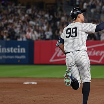 Sep 13, 2024; Bronx, New York, USA; New York Yankees center fielder Aaron Judge (99) celebrates while running the bases after hitting a grand slam home run during the seventh inning against the Boston Red Sox at Yankee Stadium. Mandatory Credit: Vincent Carchietta-Imagn Images