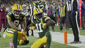 Nov 28, 2024; Green Bay, Wisconsin, USA; Green Bay Packers wide receiver Jayden Reed (11) celebrates his touchdown reception with wide receiver Christian Watson (9) during the second quarter at Lambeau Field. Mandatory Credit: Mark Hoffman-Imagn Images