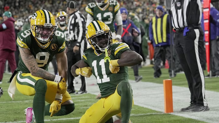 Nov 28, 2024; Green Bay, Wisconsin, USA; Green Bay Packers wide receiver Jayden Reed (11) celebrates his touchdown reception with wide receiver Christian Watson (9) during the second quarter at Lambeau Field. Mandatory Credit: Mark Hoffman-Imagn Images