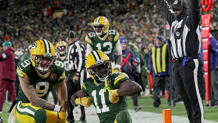 Green Bay Packers wide receiver Jayden Reed (11) celebrates his touchdown reception with wide receiver Christian Watson (9) during the second quarter of their game against the Miami Dolphins Thursday, November 28, 2024 at Lambeau Field in Green Bay, Wisconsin.