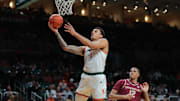 Jan 8, 2025; Coral Gables, Florida, USA; Miami Hurricanes center Lynn Kidd (1) drives to the basket past Florida State Seminoles forward Malique Ewin (12) during the second half at Watsco Center. Mandatory Credit: Sam Navarro-Imagn Images