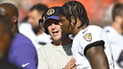 Baltimore Ravens head coach John Harbaugh talks with quarterback Lamar Jackson against the Cleveland Browns.