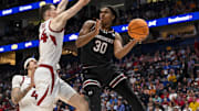 Mar 12, 2025; Nashville, TN, USA;  South Carolina Gamecocks forward Collin Murray-Boyles (30) passes the ball under the arms of Arkansas Razorbacks forward Zvonimir Ivisic (44) during the second half at Bridgestone Arena. Mandatory Credit: Steve Roberts-Imagn Images