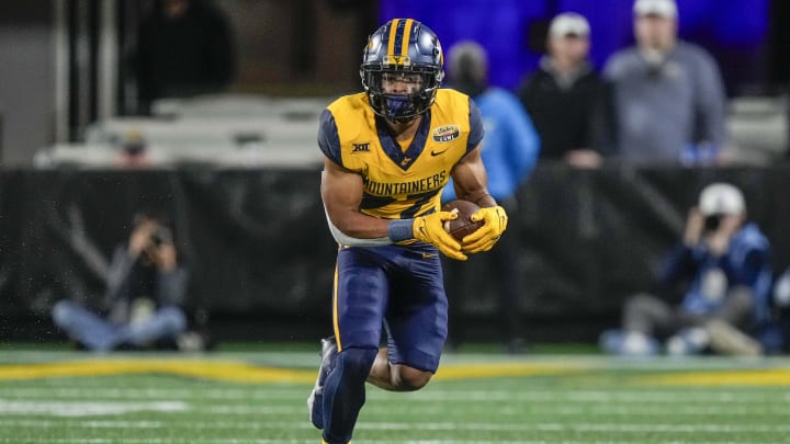 Dec 27, 2023; Charlotte, NC, USA; West Virginia Mountaineers running back Jahiem White (22) runs for a first down.