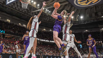 Mar 10, 2024; Greensville, SC, USA; Louisiana State University guard Hailey Van Lith (11) takes a shot over a couple of South Carolina defenders.