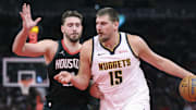 Nov 21, 2025; Houston, Texas, USA; Denver Nuggets center Nikola Jokic (15) controls the ball as Houston Rockets center Alperen Sengun (28) defends during the fourth quarter at Toyota Center.