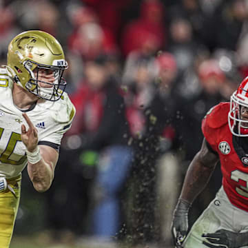 Nov 29, 2024; Athens, Georgia, USA; Georgia Tech Yellow Jackets quarterback Haynes King (10) tries to escape the rush of Georgia Bulldogs linebacker CJ Allen (3) during overtime at Sanford Stadium. Mandatory Credit: Dale Zanine-Imagn Images