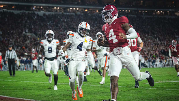 Alabama Crimson Tide quarterback Jalen Milroe scores a touchdown against the Auburn Tigers.