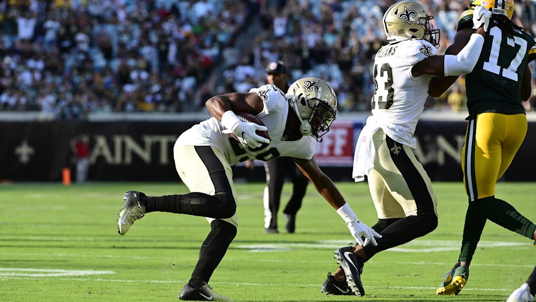 Paulson Adebo (29) returns a interception during the second half against the Green Bay Packers in 2021.