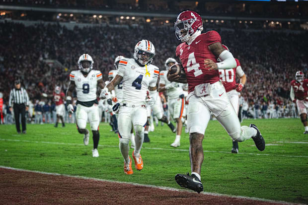 Alabama Crimson Tide QB Jalen Milroe scores a touchdown against the Auburn Tigers. Alabama Crimson Tide QB Jalen Milroe scores a touchdown against the Auburn Tigers.