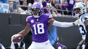 Oct 1, 2023; Charlotte, North Carolina, USA;  Minnesota Vikings wide receiver Justin Jefferson (18) in the end zone past Carolina Panthers cornerback CJ Henderson (23) during the first quarter at Bank of America Stadium. Mandatory Credit: Jim Dedmon-Imagn Images