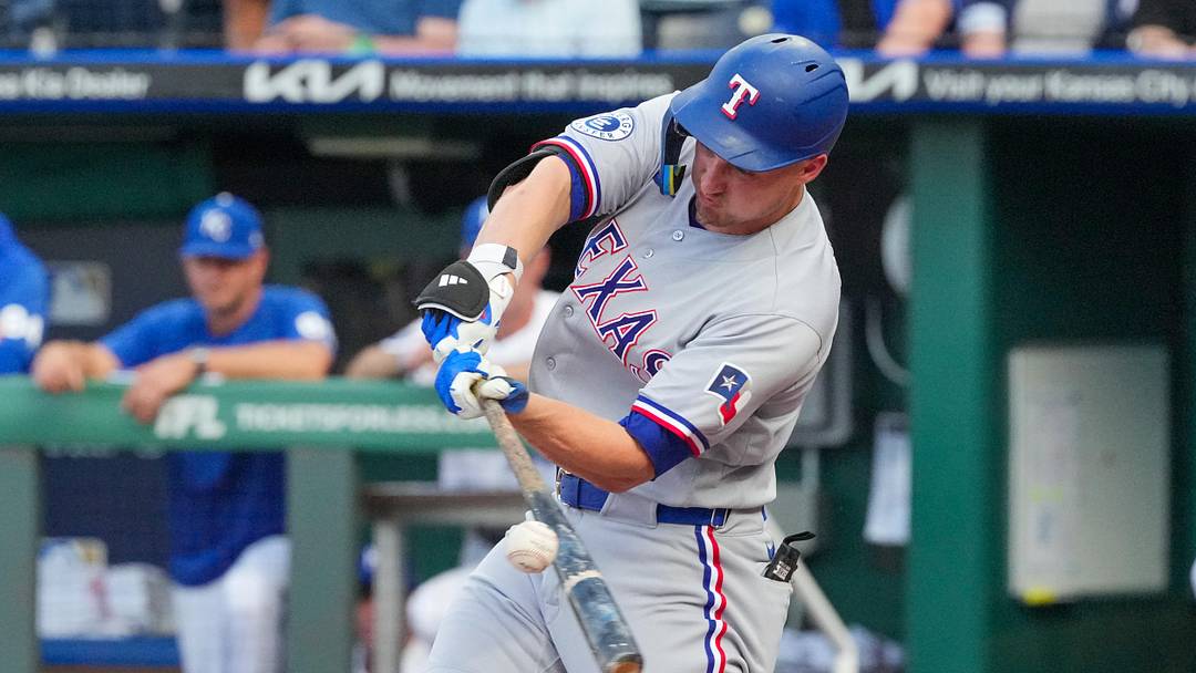 Jun 9, 2026; Kansas City, Missouri, USA; Texas Rangers shortstop Corey Seager (5) hits a single against the Kansas City Royals during the first inning at Kauffman Stadium. Mandatory Credit: Denny Medley-Imagn Images