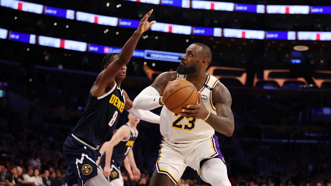 Nov 23, 2024; Los Angeles, California, USA;  Los Angeles Lakers forward LeBron James (23) looks to shoot against Denver Nuggets forward Peyton Watson (8) during the fourth quarter at Crypto.com Arena. Mandatory Credit: Kiyoshi Mio-Imagn Images