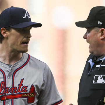 Jun 11, 2024; Baltimore, Maryland, USA;  Atlanta Braves pitcher Max Fried (54) speaks with home plate umpire Chad Whitson (62) while walking to the dugout after the first inning of the game against the Baltimore Orioles at Oriole Park at Camden Yards.