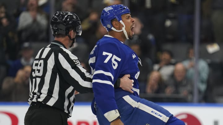 Feb 29, 2024; Toronto, Ontario, CAN; Toronto Maple Leafs forward Ryan Reaves (75) reacts after a fight with Arizona Coyotes forward Liam O'Brien (not pictured) as linesperson Steve Barton (59) guides him to the penalty box during the first period at Scotiabank Arena. Mandatory Credit: John E. Sokolowski-USA TODAY Sports