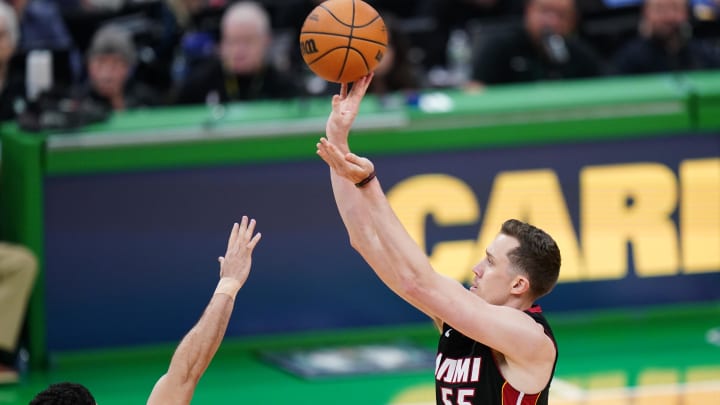 Apr 24, 2024; Boston, Massachusetts, USA; Miami Heat forward Duncan Robinson (55) shoots for three points against Boston Celtics forward Jayson Tatum (0) in the second half during game two of the first round for the 2024 NBA playoffs at TD Garden. Mandatory Credit: David Butler II-USA TODAY Sports