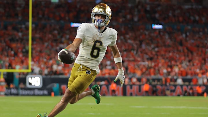 Aug 31, 2025; Miami Gardens, Florida, USA; Notre Dame Fighting Irish wide receiver Jordan Faison (6) scores a touchdown against the Miami Hurricanes during the third quarter at Hard Rock Stadium. Mandatory Credit: Sam Navarro-Imagn Images