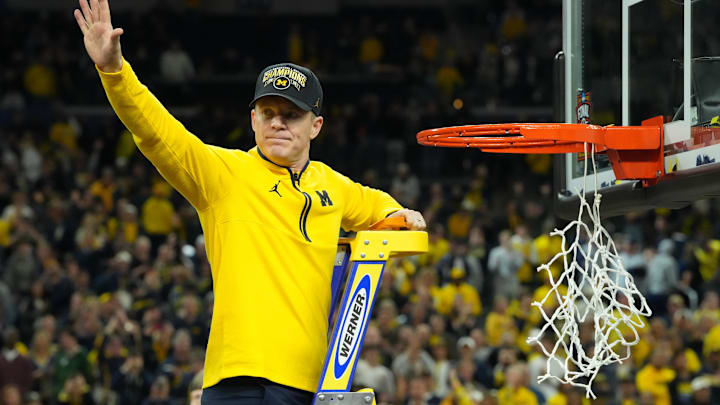 Apr 6, 2026; Indianapolis, IN, USA; Michigan Wolverines head coach Dusty May waves to the crowd as he cuts down the net after defeating the Connecticut Huskies in the national championship of the Final Four of the men's 2026 NCAA Tournament at Lucas Oil Stadium. Mandatory Credit: Robert Deutsch-Imagn Images