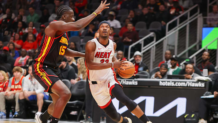 Apr 9, 2024; Atlanta, Georgia, USA; Miami Heat forward Jimmy Butler (22) drives on Atlanta Hawks center Clint Capela (15) in the first quarter at State Farm Arena. Mandatory Credit: Brett Davis-Imagn Images