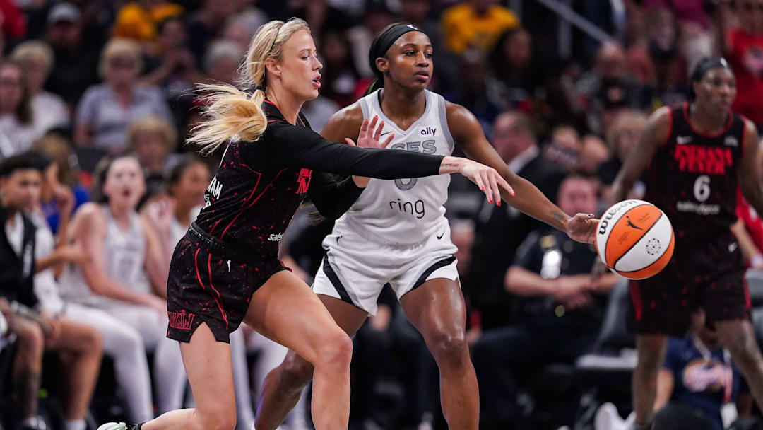 Indiana Fever guard Sophie Cunningham (8) passes the ball against Las Vegas Aces guard Jackie Young (0) on Thursday, July 24, 2025, during the game at Gainbridge Fieldhouse in Indianapolis.