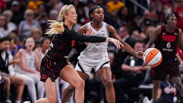 Indiana Fever guard Sophie Cunningham (8) passes the ball against Las Vegas Aces guard Jackie Young (0) on Thursday, July 24, 2025, during the game at Gainbridge Fieldhouse in Indianapolis.